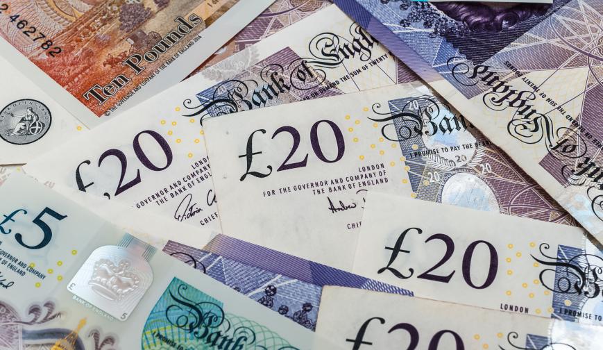 An image of twenty pound notes in a pile
