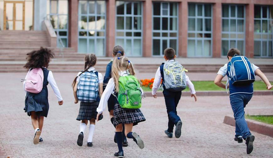 Children running into school