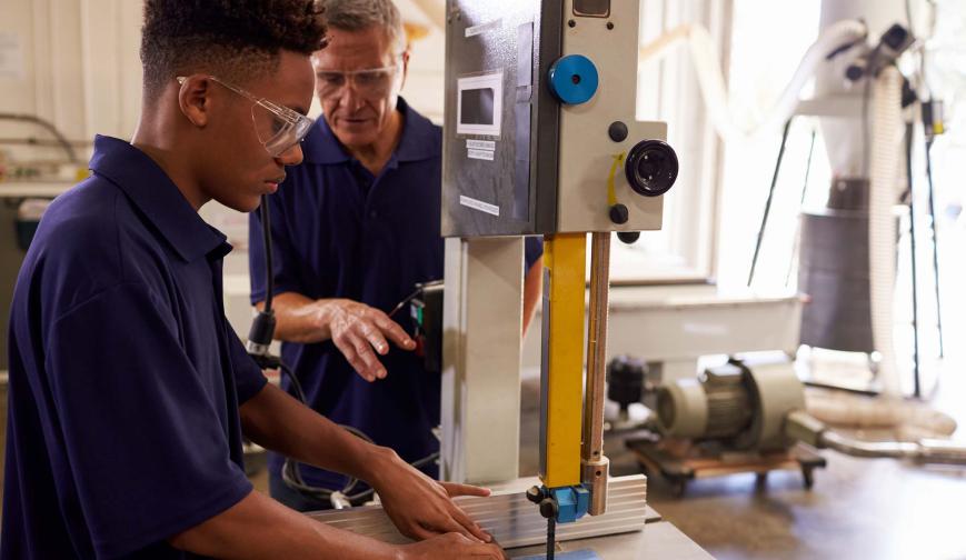 Apprentice using saw