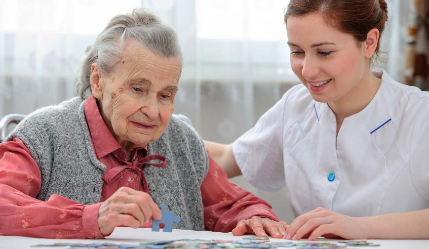 Social care worker with elderly patient