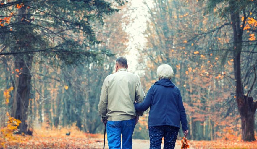 retired couple walking in park