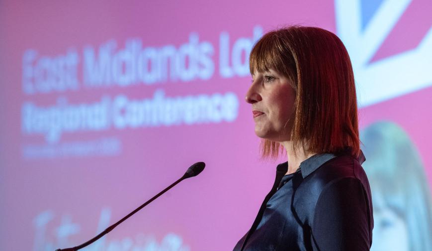 Side profile of Rachel Reeves standing in front of a microphone at a conference