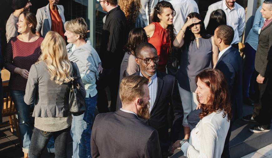 A photo of people socialising at a conference
