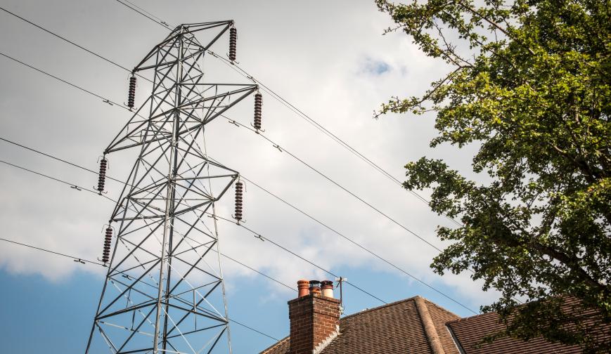 Image of powerlines passing over a residential home