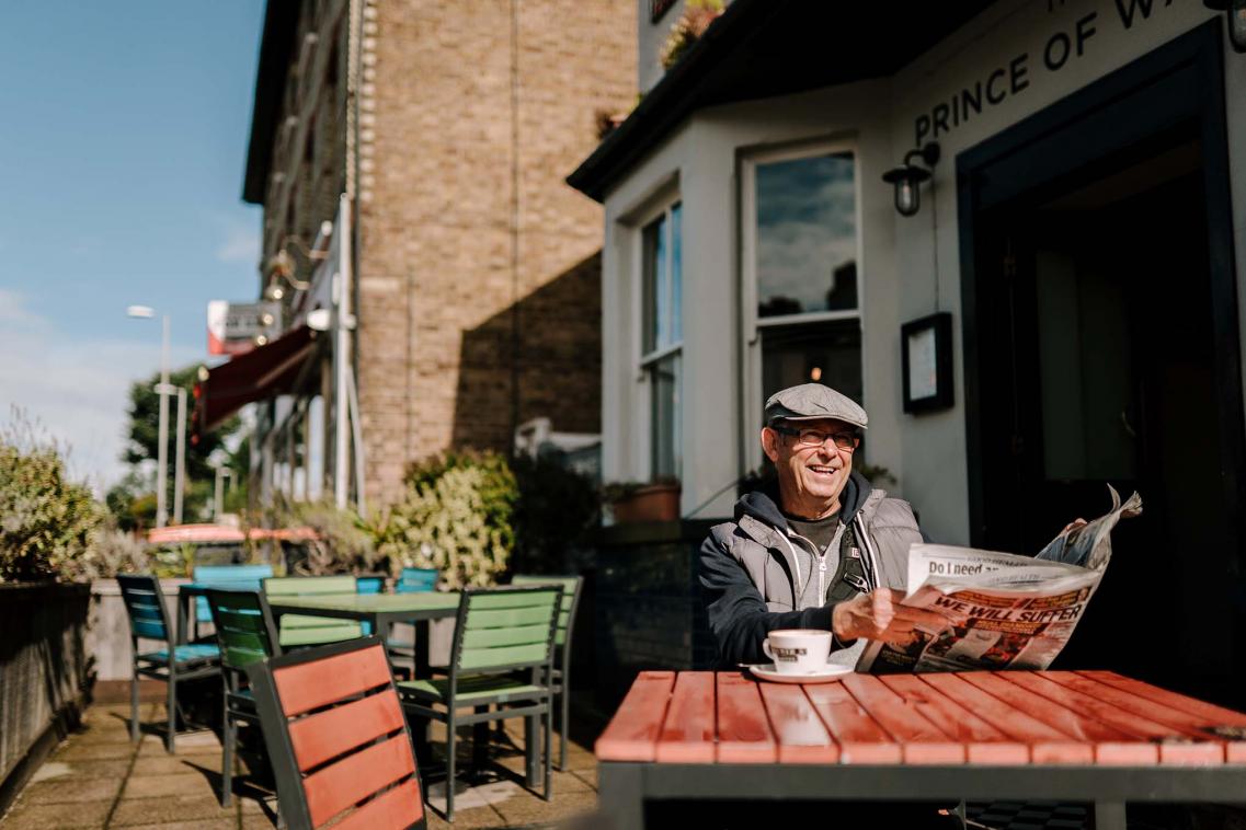 Older man reads newspaper