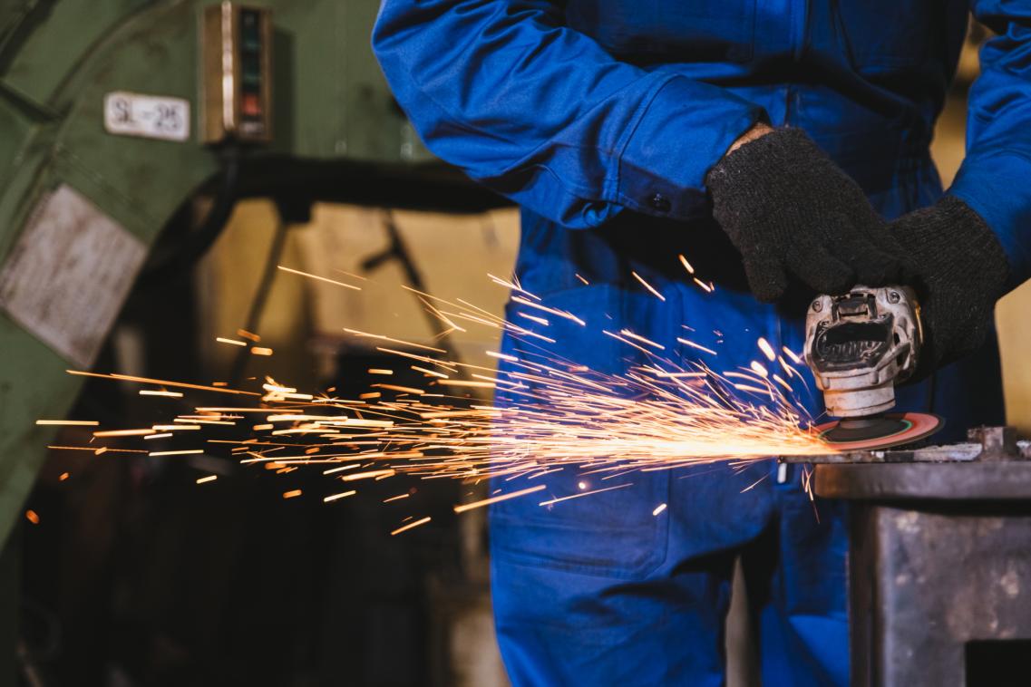 An image of someone operating an angle grinder