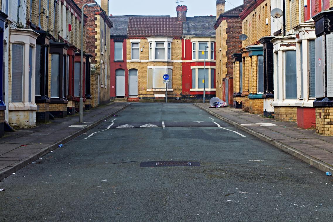 An image of a street full of boarded up houses