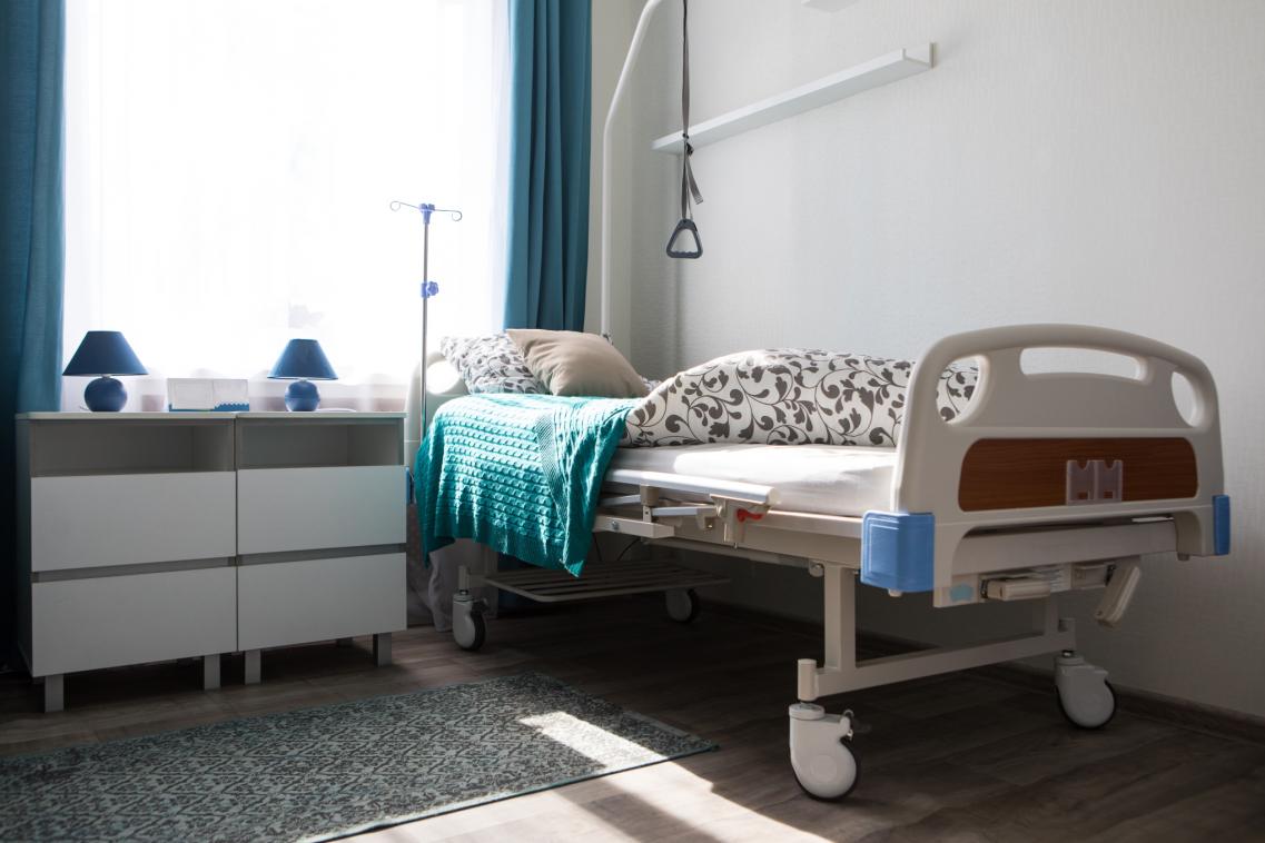 An image of an empty bed in a care home