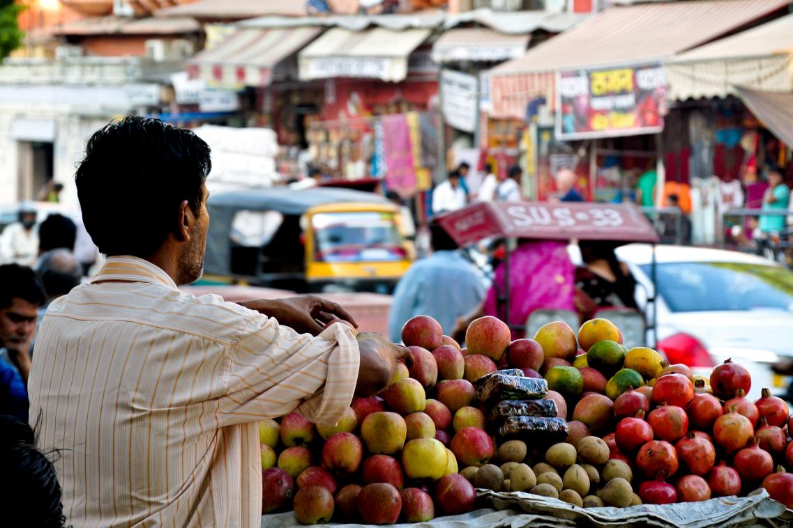 Image of a man waiting to sell produce from his fruit market