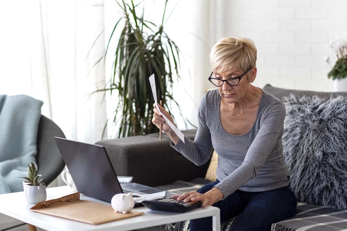 Older woman looking at bills