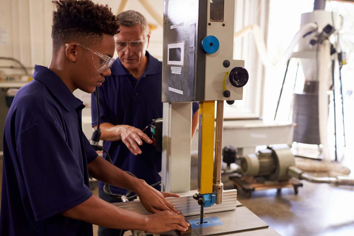 Apprentice using saw