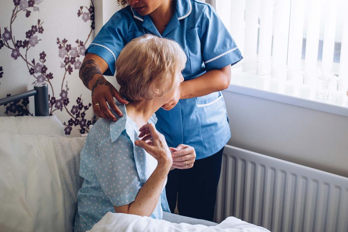 Elderly woman with carer