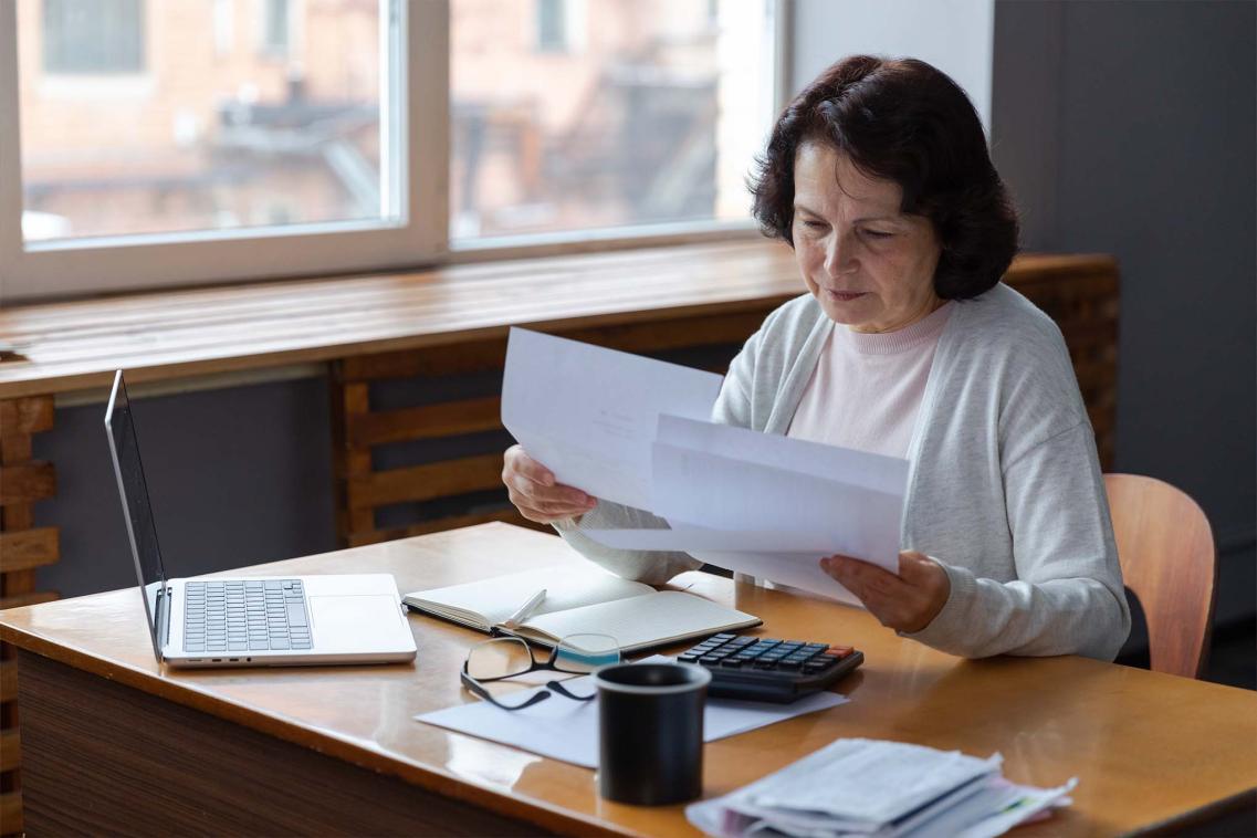 Middle-aged women looking at documents