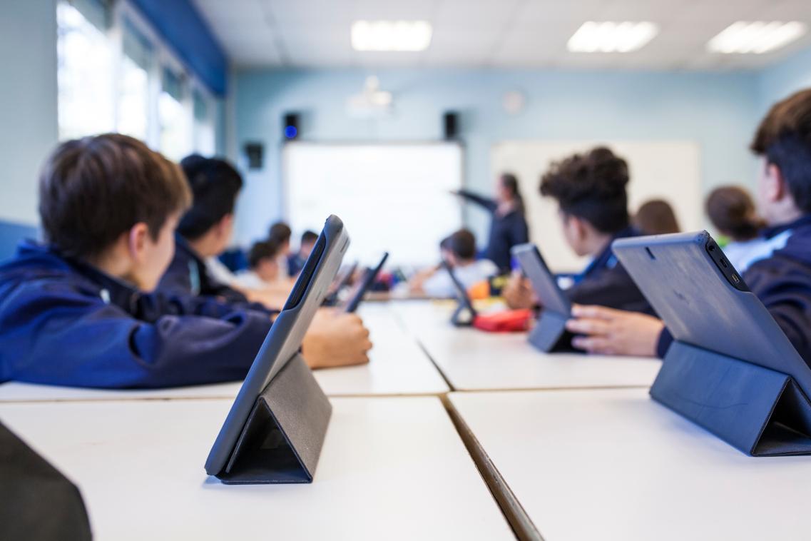 Image of classroom with children using electronic tablets