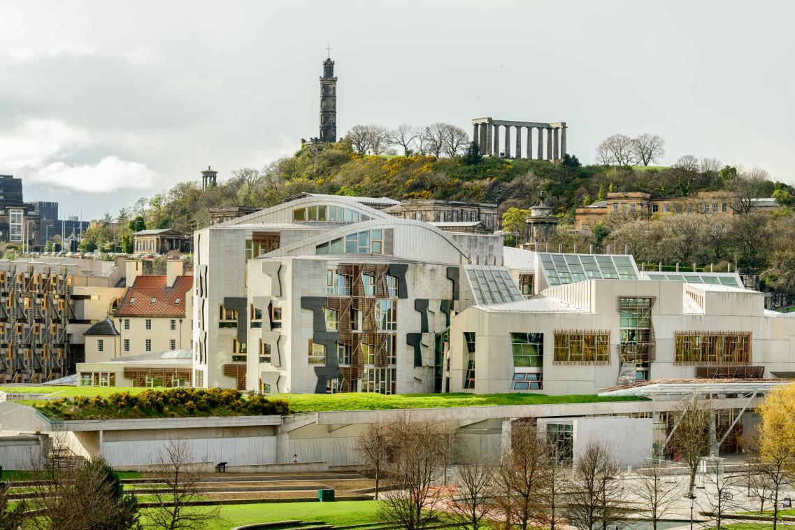 Image of the Scottish Parliament building with Calton Hill behind