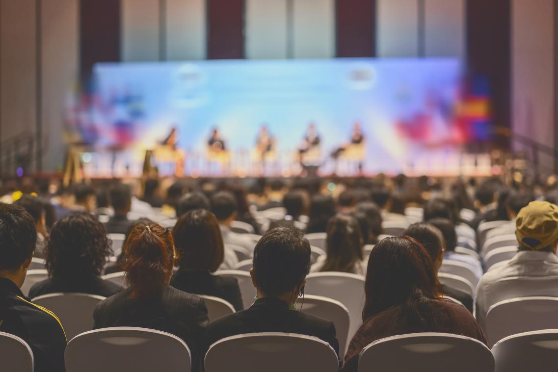 Image of people sitting at a conference