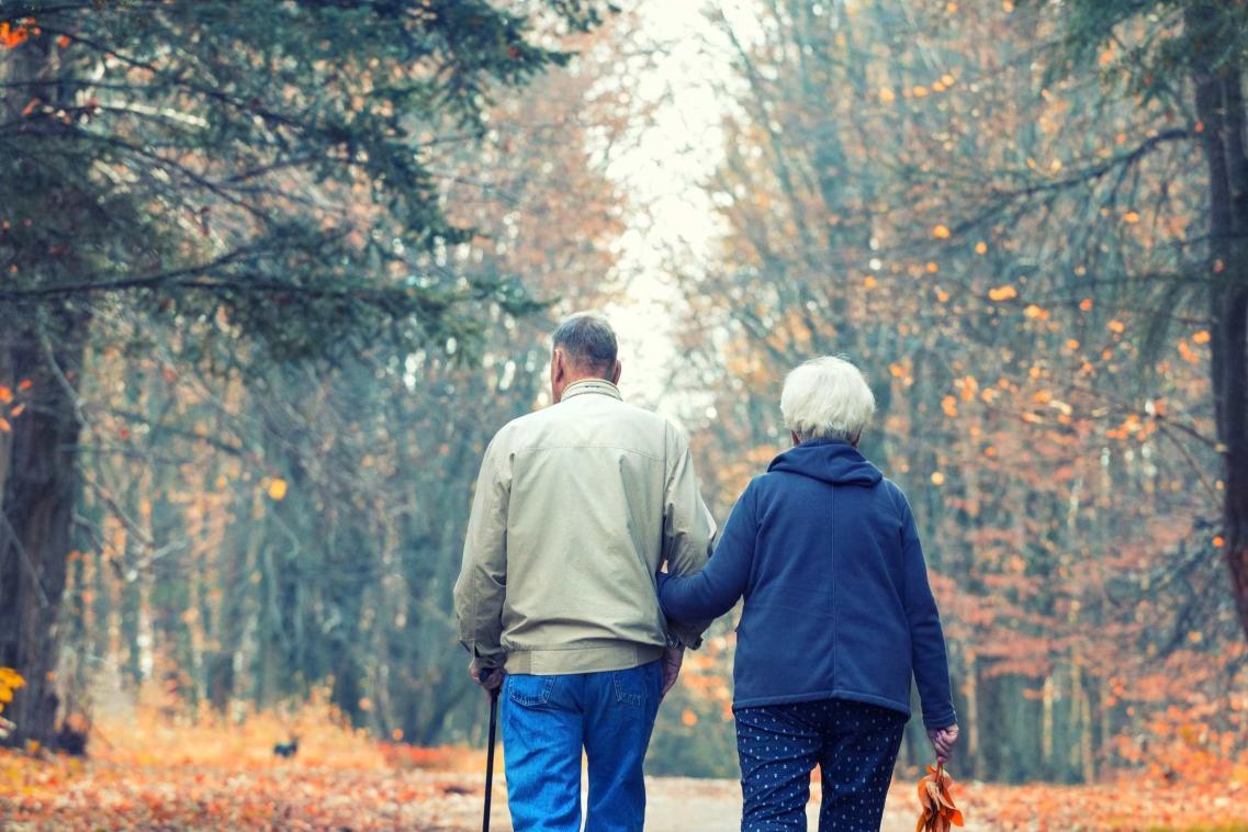 retired couple walking in park