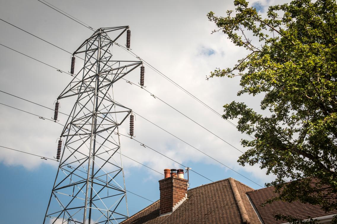 Image of powerlines passing over a residential home