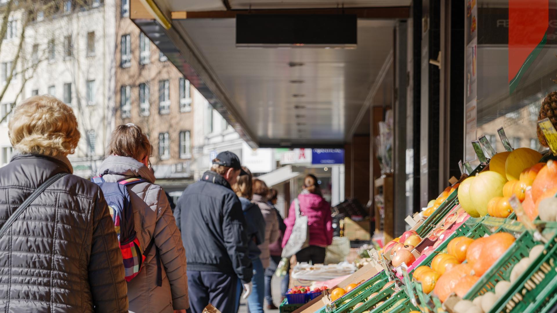 An image of people shopping for fruit