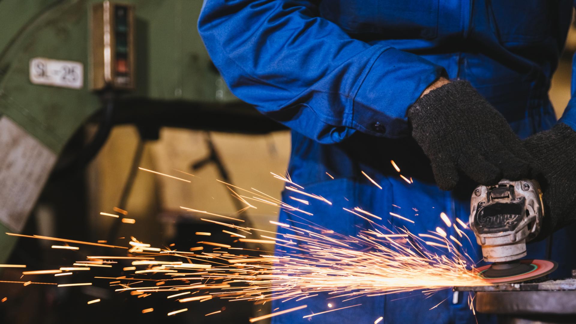 An image of someone operating an angle grinder