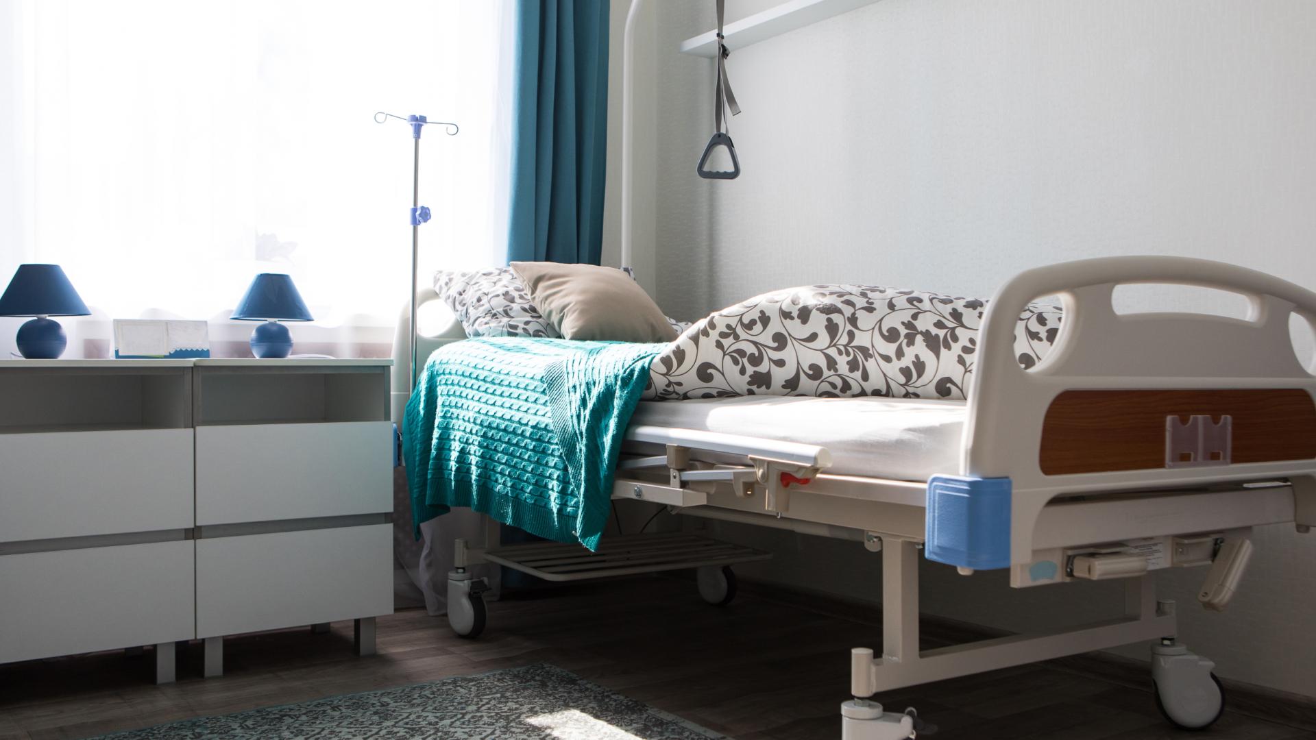 An image of an empty bed in a care home