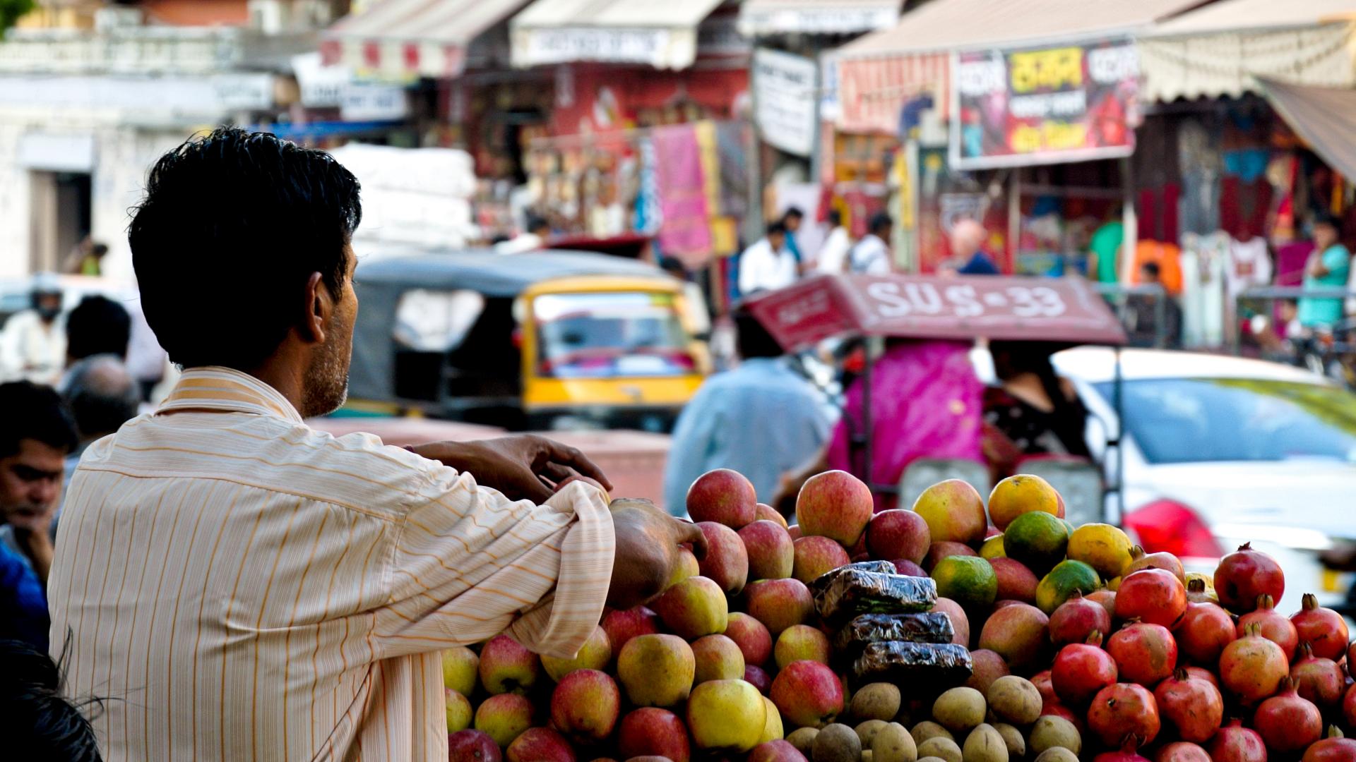 Image of a man waiting to sell produce from his fruit market 