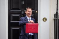 A photo of Jeremy Hunt holding the budget box