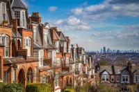 A photo of houses with London in the background
