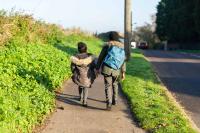 Two children walking to school