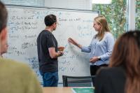 IFS Staff in front of a whiteboard