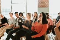 Image of a woman asking a question in a conference