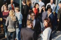 A photo of people socialising at a conference