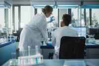 Image of two colleagues in a research lab looking at a Petri Dish.