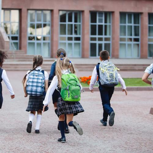 Children running into school