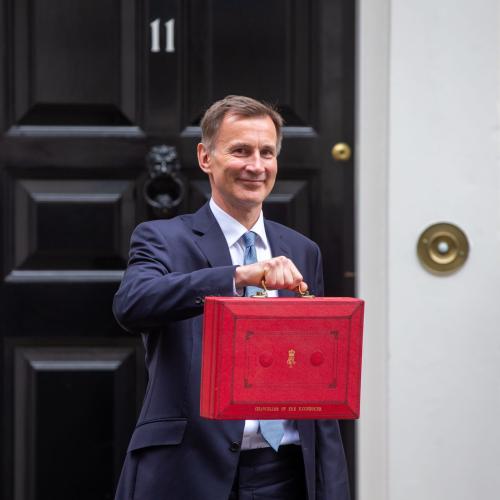 A photo of Jeremy Hunt holding the budget box