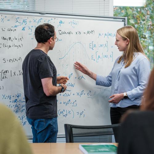 IFS Staff in front of a whiteboard