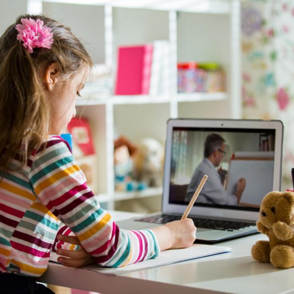 An image of a child using a laptop to learn from home