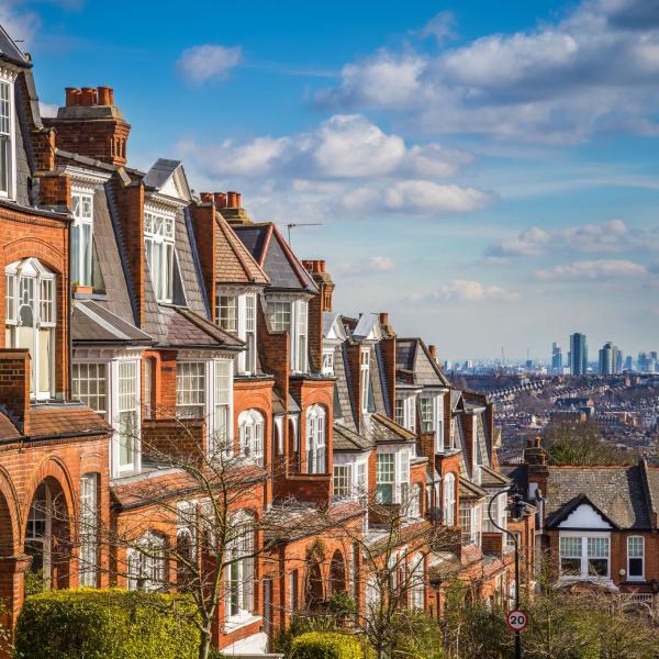 A photo of houses with London in the background