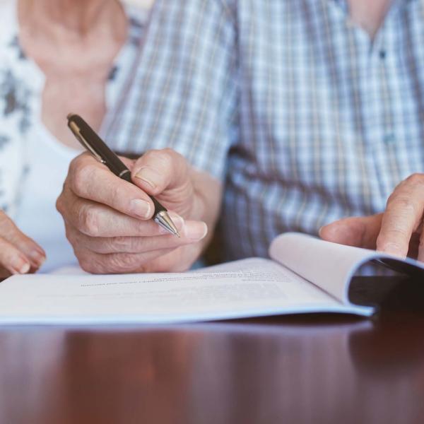 Older couple signing document