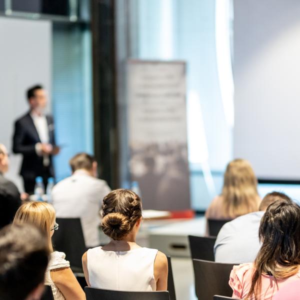 Image of speaker talking in a lecture theatre