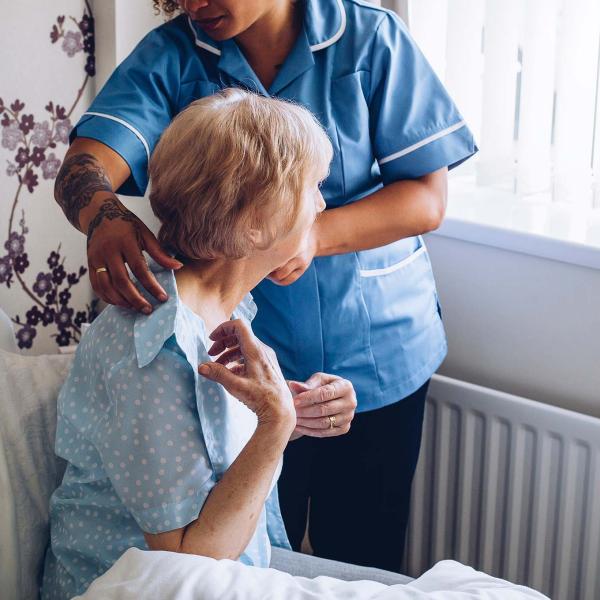 Elderly woman with carer