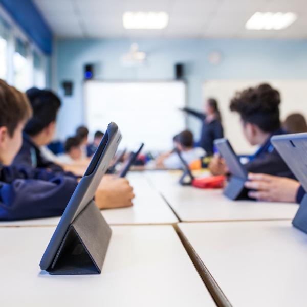 Image of classroom with children using electronic tablets