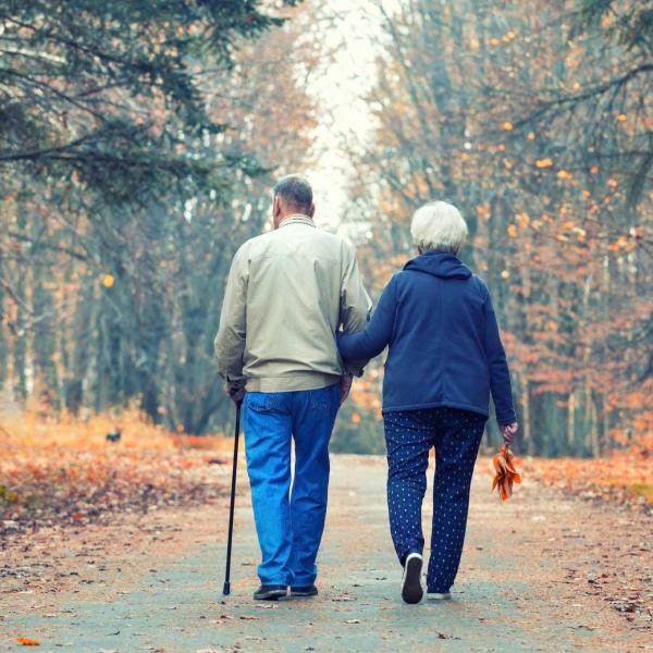 retired couple walking in park