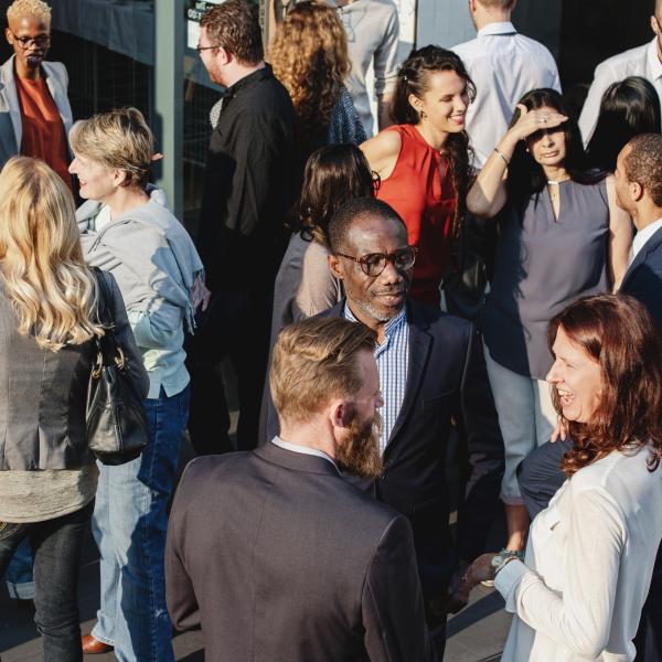 A photo of people socialising at a conference